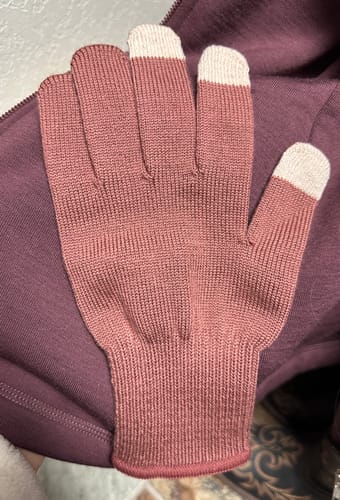 Customer's Wild Ginger Asher Tech Glove with white tech tips, laid flat on a purple jacket to show the color.