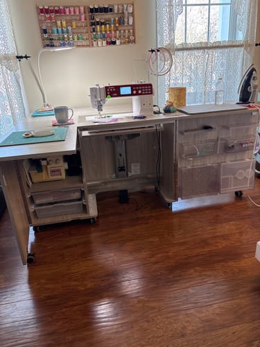 Customer's Grey Oak Koala Eclipse Sewing Cabinet set up in a sewing room with a machine on its lift and extensions open.