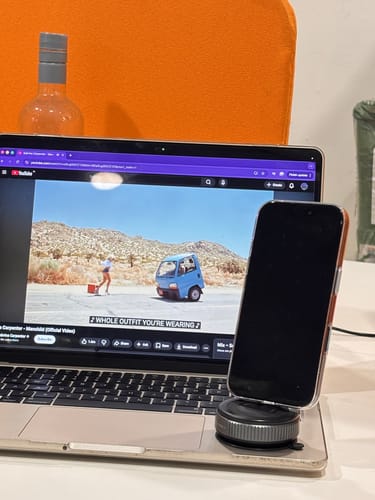 Customer's MagPro Magnetic Phone Holder securely holding a phone in its case, placed on a laptop.