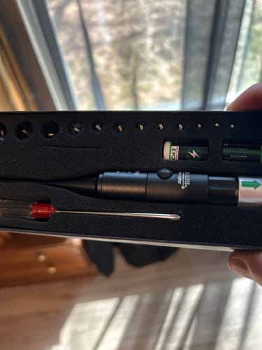 Customer displays the Site Right™ 2.0 - Boresighter kit in its open case, showing the tool, batteries, and accessories.