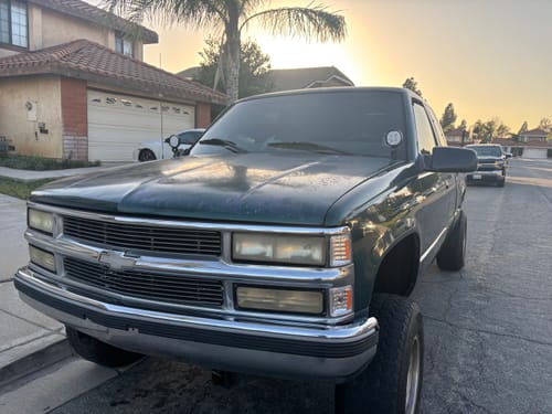 Customer's green Chevy C/K pickup with a hood ditch light mount installed on the driver's side near the windshield.