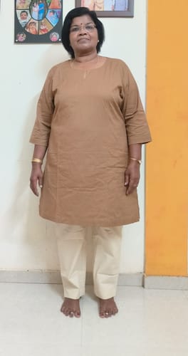 Customer showing the full-length view and fit of the Women Beige Cotton Pant indoors.