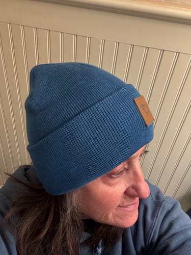 Customer wearing the blue ribbed Kids Baylor Beanie, showing the fit with its folded cuff.
