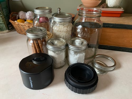 Customer's black Mason Genie Vacuum Sealer Kit on a countertop with several glass mason jars of various sizes.