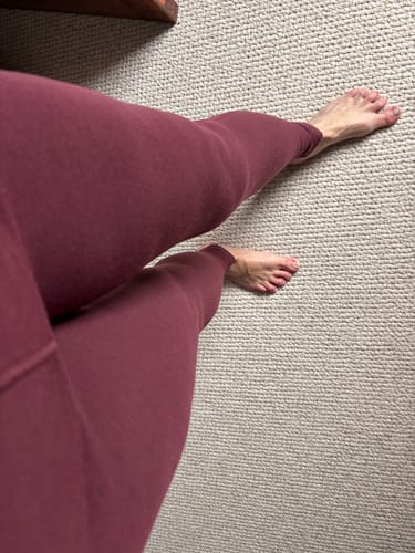 Reviewer's first-person view of the Piper Pocket Petite leggings in Toasted Garnet, showing the ankle-length fit.