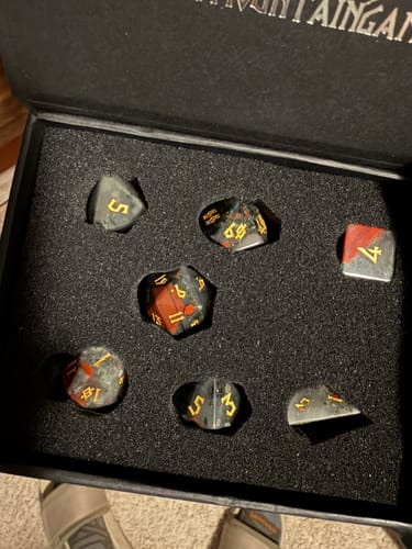 Customer's African Bloodstone dice set with dark stone and red splotches displayed in its black box.