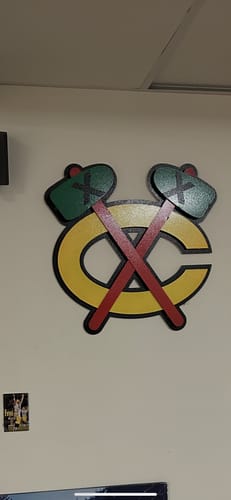 Customer's Chicago Blackhawks 'TOMAHAWKS C' 3D vintage metal wall art mounted on a wall.