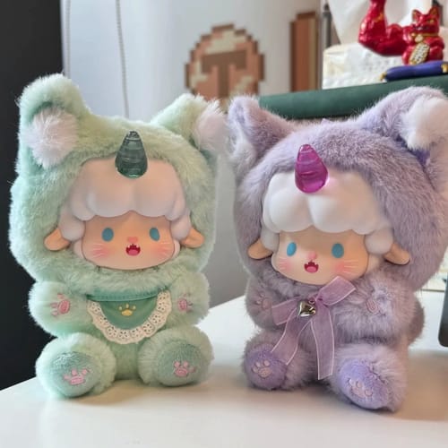 Customer's two fluffy A Gyun plush toys, one mint green and one lavender, shown sitting together on a white table.
