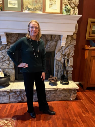 Reviewer standing indoors wearing the black Luca Ribbed Pants, showing the full-length wide-leg fit.