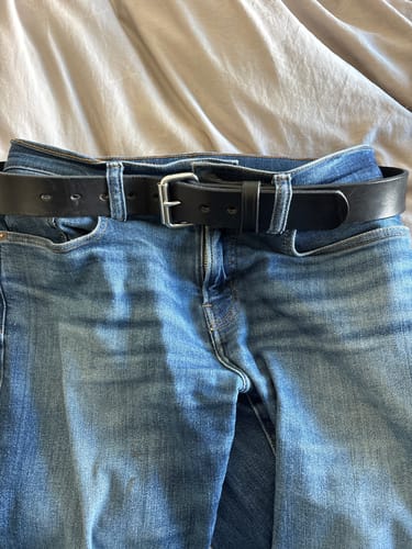 Customer's black Gunner belt with a silver buckle threaded through a pair of blue jeans.