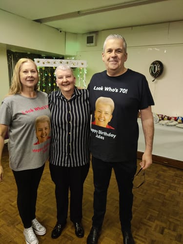Reviewers wearing custom-printed Super-soft Heavy Tees for a 70th birthday party.