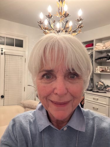 A smiling customer shows her healthy-looking skin after using the Grass Fed Tallow & Honey Balm.