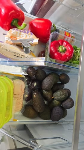 Eine Kundin zeigt die vielen kleinen Bio-Hass-Avocados in ihrem Kühlschrankfach.