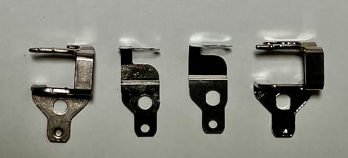 Reviewer compares old, worn Thread Guide Assembly parts on the left with the new replacement parts on the right.