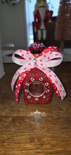 Customer's Don Julio Tequila Mini Shot decorated as a festive gift with red glitter and a bow.