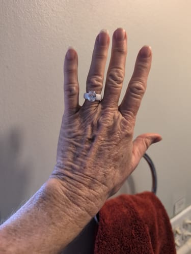 Customer showing the white Silicone Ring with a large oval stone on their hand.