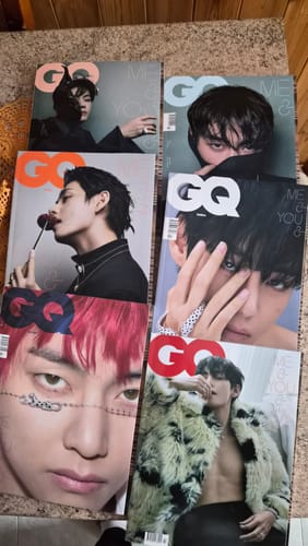 Customer's set of six different GQ magazine covers featuring BTS V, all spread out on a surface.