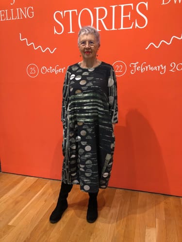 Reviewer at a workshop event wearing the full-length Balloon Moonlight Cotton Dress with black boots.