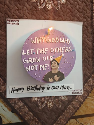 Customer's purple Joey Meme Cake with 'Why God Why' text and a single lit candle for a birthday.