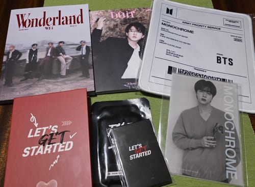 Customer's items from the K-POP RANDOM BOX, including a WEi album, BTS merchandise, and various photobooks and cards.
