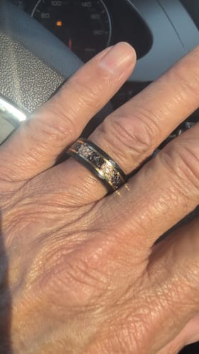 Customer wearing the black Titanfall ring with a textured meteorite and gold flake inlay.
