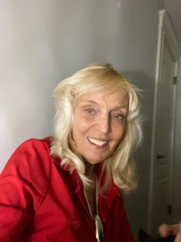 Reviewer showing her face, smiling after using Grass Fed Tallow & Honey Balm.