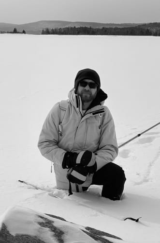 Reviewer wearing the Wilder Shirt Jac while kneeling in a snowy outdoor setting.