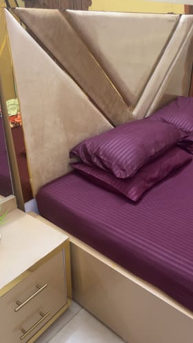 Customer's MAROON stripe satin fitted bedsheet and matching pillows on a bed.