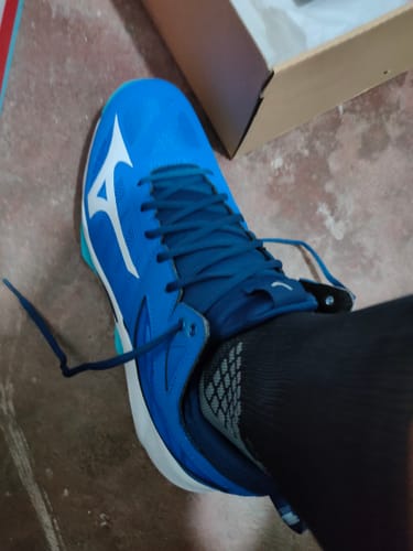 Reviewer's foot wearing the blue Mizuno Wave Dimension Mid Volleyball Shoe with a black sock.