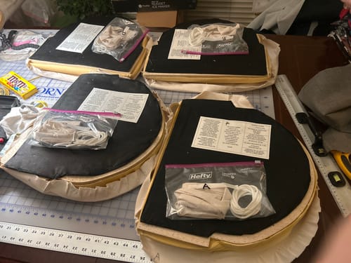 Customer using the large Horn of America Cutting Mat for an upholstery project, with several chair seats placed on top.