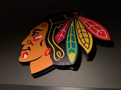 Customer's close-up shot of the Chicago Blackhawks 3D Vintage Metal Wall Art on a dark wall.