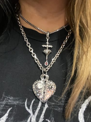 Reviewer wearing the 4mm Mini Cuban Chain layered above a thicker silver necklace with pendants.