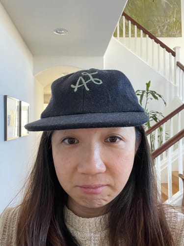 Customer's "before" photo showing a different, ill-fitting baseball cap sitting high on their head.