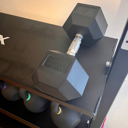 Customer's black 20kg Hex Dumbbell resting on a gym storage rack.