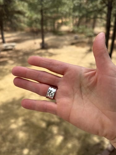 Reviewer showing the inside of the wide Textured Band Ring on their finger.