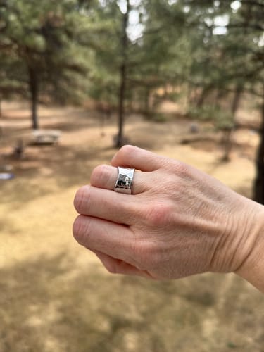 Reviewer's hand in a fist wearing the silver Textured Band Ring.