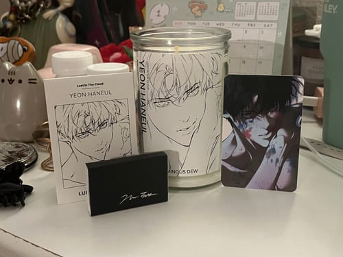 Customer's Lost in the Cloud candle package, with the candle, matchbox, and photocard neatly displayed on a desk.