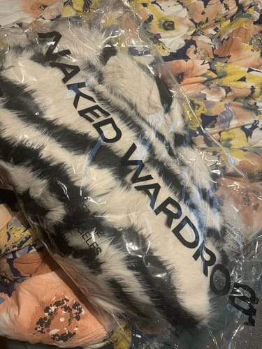Customer's Faux Fur Plush Zebra Coat shown inside its original clear packaging.
