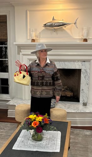 Reviewer in a western-style hat and jacket posing in costume for the Wild West Murder Mystery game.