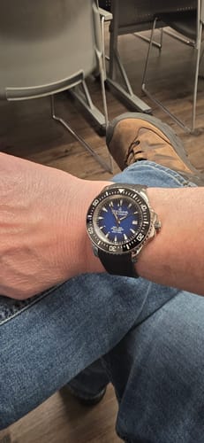 Reviewer wearing the Oceaneva Deep Marine Explorer watch, showing its vibrant blue dial and black strap.