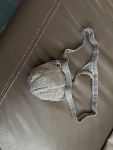 Customer's heather gray Modal Thong showing the pouch and string design on a brown surface.