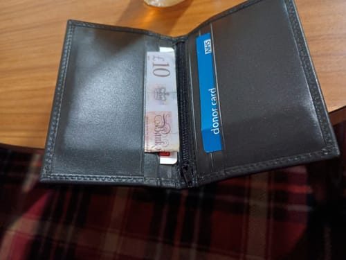 Reviewer's black leather Viper Wallet shown open, revealing interior pockets with cash and cards.