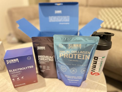 Customer shows their delivered supplements, unboxed on a table with the shipping box behind.