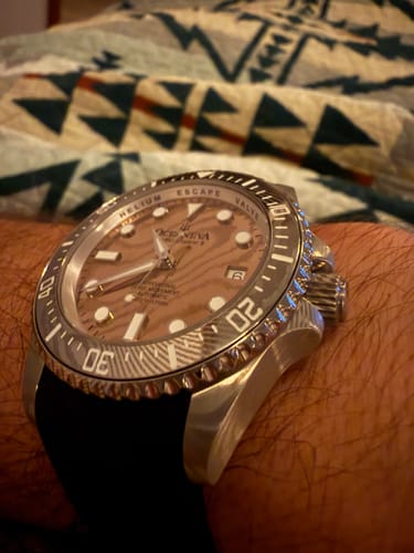 Close-up of a customer wearing the Oceaneva watch, showing the textured rose gold Damascus steel dial on their wrist.