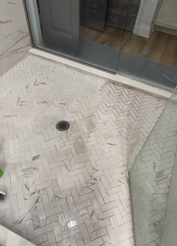 Customer's before-and-after view of a shower floor cleaned with Bathroom Concentrate.