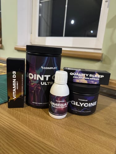 Customer's Better Sleep Bundle products, including Glycine and Melatonin Spray, arranged on a wooden desk.