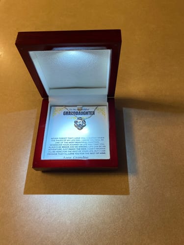 Customer's Love Knot Gift Set presented in its open, illuminated mahogany-style box.