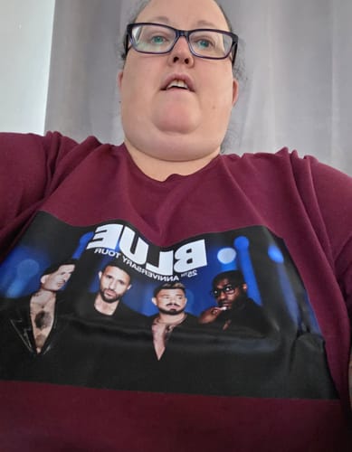 Customer wearing a maroon unisex t-shirt with a large graphic print on the front.