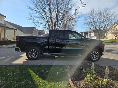Customer's black Chevy Silverado truck parked in a driveway before installing the 2" rear lift kit.