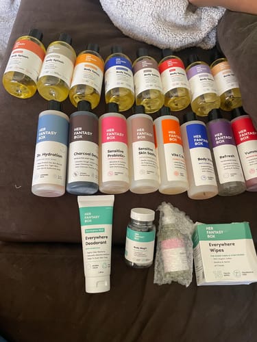 A reviewer's complete Everything Body Care Bundle, showing all the washes, oils, deodorant, and wipes laid out.